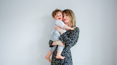 Anne ve oğlu evde beyaz duvar arka plan üzerinde