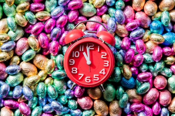 Color Chocolate Huevos de Pascua y despertador en él — Foto de Stock