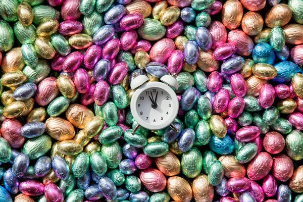 Olor csokoládé húsvéti tojások és alarm clock rajta — Stock Fotó