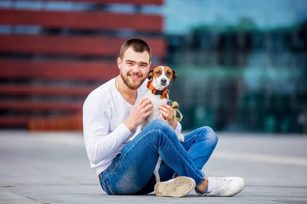 Man with his dog, Jack Russell Terrier, on the city street — Stock Photo, Image