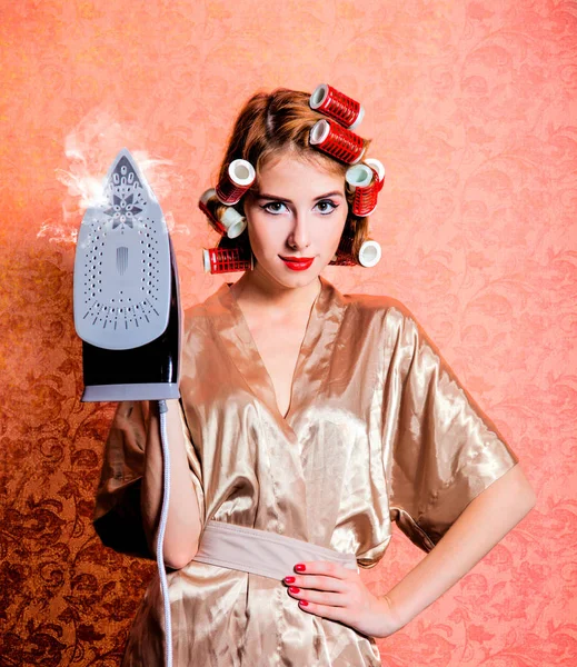 Housewife with iron and curler — Stock Photo, Image