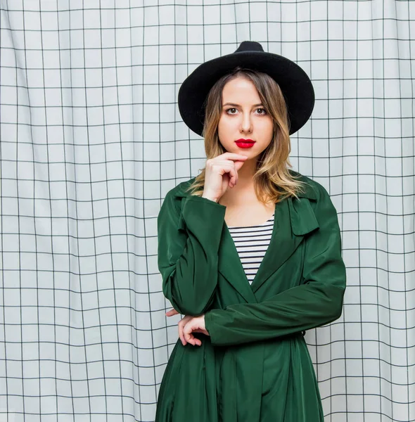 Young style woman in hat and green cloak in 90s style — Stock Photo, Image