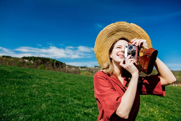 Hermosa chica en vestido rojo y sombrero tienen un tiempo sin preocupaciones con vi — Foto de Stock