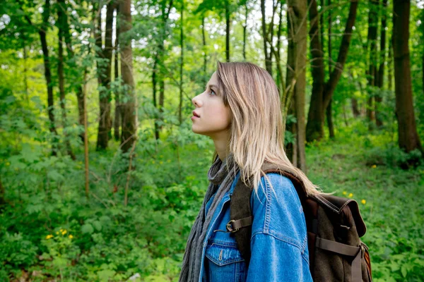 Ung kvinna med ryggsäck i blandskog — Stockfoto