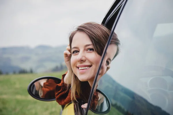 Donna seduta in una piccola auto su un posto di guida — Foto Stock