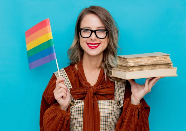 Young woman with books and LGBT flag — 스톡 사진