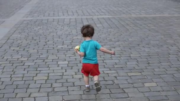 在老城的人行道上行走的蹒跚学步的男孩 — 图库视频影像