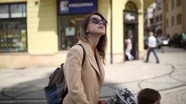 Mother with a toddler boy in old city center. — Stock Video