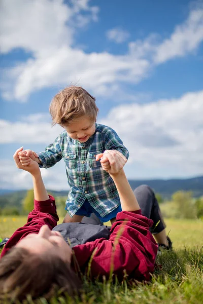 Mutter vergnügt sich mit Sohn auf einer Wiese in den Bergen — Stockfoto