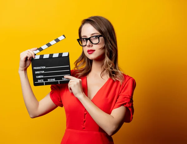Beautiful woman in red dress with clapperboard — Stock Photo, Image