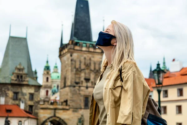 girl in face mask on the street of Prague in the pandemic