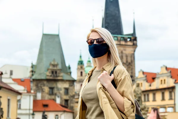 girl in face mask on the street of Prague in the pandemic