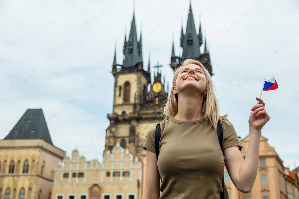 Blonde woman with a flag at central square in Prague, Czech Republic