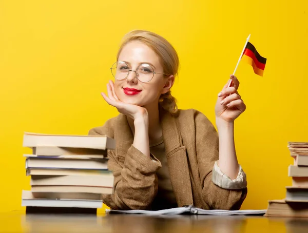 Style Blonde Woman Sitting Table Books Flag Germany Yellow Background — Stock Photo, Image