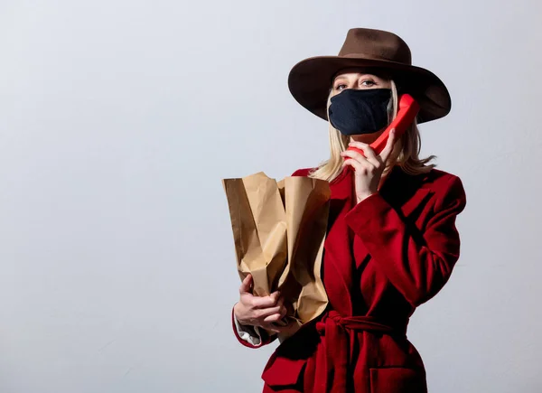 Blonde Girl Red Coat Dial Handset Paper Bags Grey Background — Stock Photo, Image