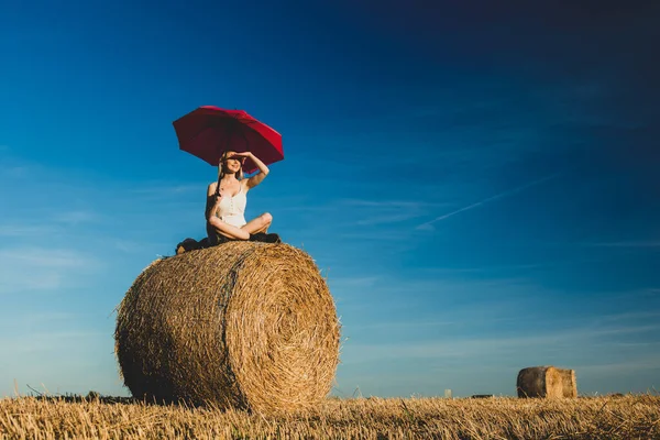 Blonde Girl Umbrella Sitting Rolled Haystack Field Sunset Time — Stock Photo, Image