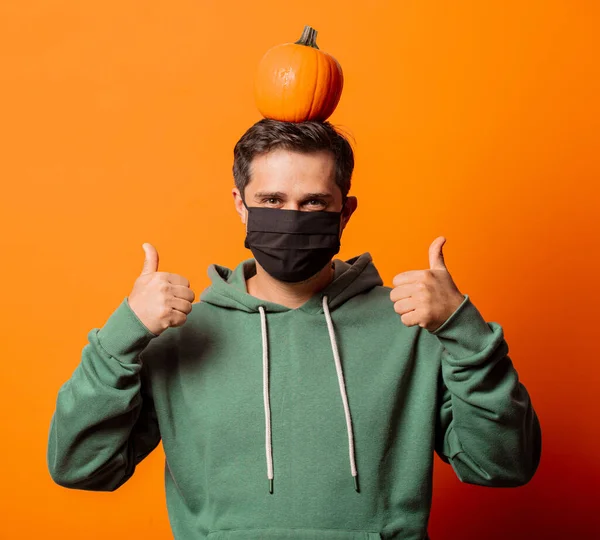 Guy Face Mask Green Hoodie Pumpkin Orange Background — Stock Photo, Image
