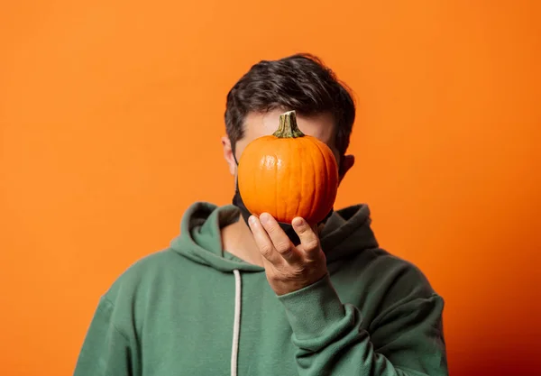 Guy Face Mask Green Hoodie Pumpkin Orange Background — Stock Photo, Image