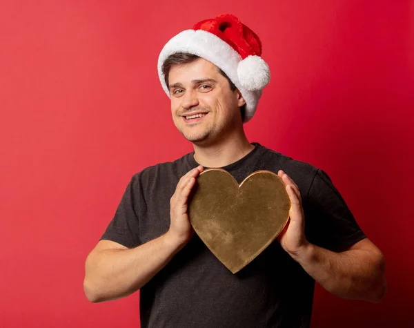 Brunette Guy Christmas Hat Heart Shape Red Background — Stock Photo, Image