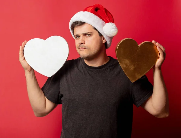 Brunette Guy Christmas Hat Heart Shape Red Background — Stock Photo, Image