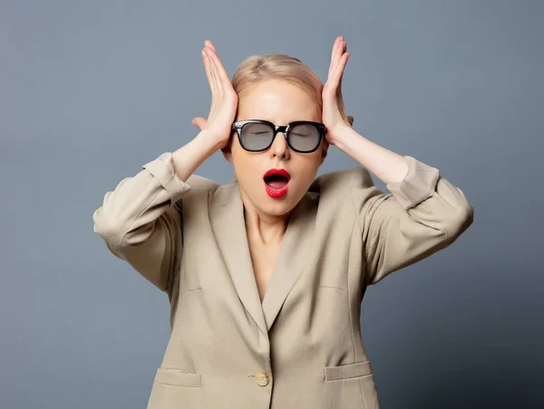 Blonde Woman Jacket Glasses Gray Background — Stock Photo, Image