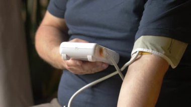 Middle-Aged Man Checking Blood Pressure at Home
