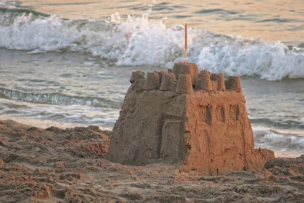 beautiful sandcastle on the background of the sea during a sunset at vacation