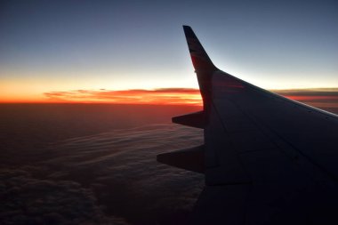 Güzel, gizemli gün batımı ve uçak penceresinden bulutlar...