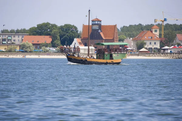 beautiful summer view from the sea of the city of Hel in Poland with a ship in the background
