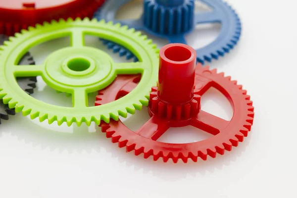 Group Plastic Colorful Clockwork Gear White Reflective Background — Stock Photo, Image