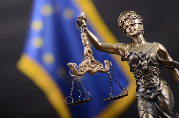 Law and Justice, Legality concept, Scales of Justice, Justitia, Lady Justice in front of the European Union flag in the background.