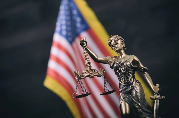 Law and Justice, Legality concept, Scales of Justice, Justitia, Lady Justice in front of the American flag in the background.