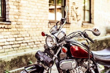 Bir tuğla duvar ve arka plan üzerinde krom kısımlarıyla motosiklet açık