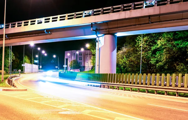 Asphalt road and Elevated Bridge at night with illuminating lamps