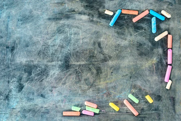 Multi-colored chalk by the sides of the board — Stock Photo, Image