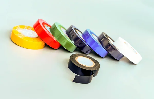 Set of multicolored insulating tapes on gray background — Stock Photo, Image