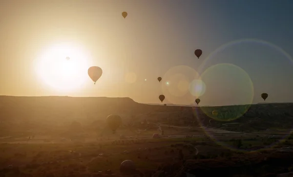 Hot air balloon flying over rock landscape at Cappadocia Turkey — Stock Photo, Image