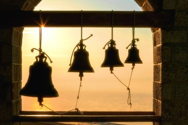 Bells at the Church on top of the Mount Athos in sinrise rays. Holy Mountain, Greece clipart