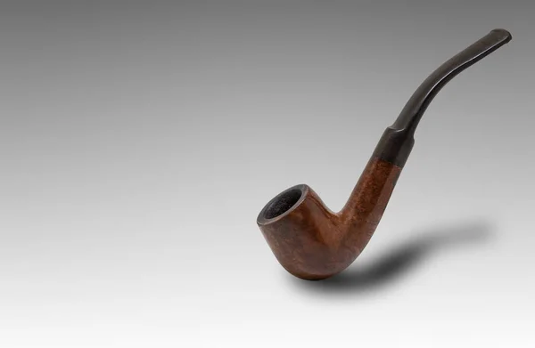 Brown color tobacco smoking pipe isolated on a white background
