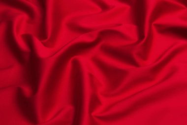 Kırmızı ipek ya da saten lüks kumaş dokusu soyut bir arka plan olarak kullanılabilir. Üst görünüm.