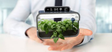 Bağlı bir dijital bitkisel bitki tutan bir Businesmann görünümünü 