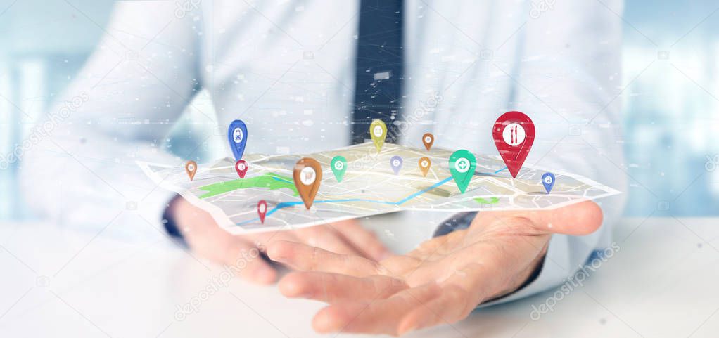 View of Businessman holding 3d rendering pin holder on map