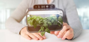 Bağlı bir dijital bitkisel bitki tutan bir Businesmann görünümünü  