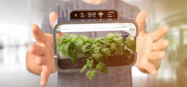 Bağlı bir dijital bitkisel bitki tutan bir Businesmann görünümünü  