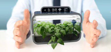 Bağlı bir dijital bitkisel bitki tutan bir Businesmann görünümünü  