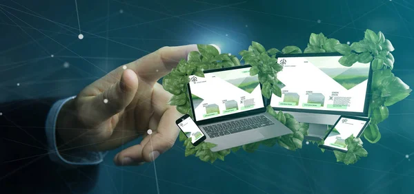 View of a Businessman holding connected devices surrounding by leaves 3d rendering