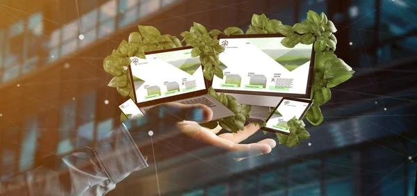 View of a Businessman holding connected devices surrounding by leaves 3d rendering