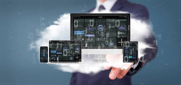 Businessman holding Devices connected to a cloud multimedia netw