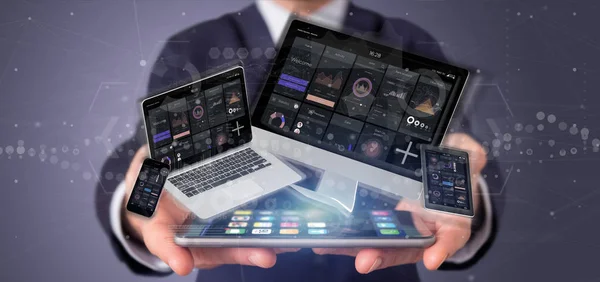 Businessman holding Devices connected to a cloud multimedia netw — Stock Photo, Image