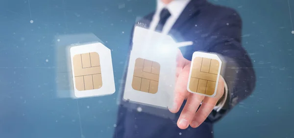 Ansicht eines Geschäftsmannes mit unterschiedlicher Größe einer Smartphone-Sim-Karte 3d-Rendering — Stockbild Geschäftsmann hält unterschiedliche Größe einer Smartphone-Sim-Karte 3d r — Stockfoto